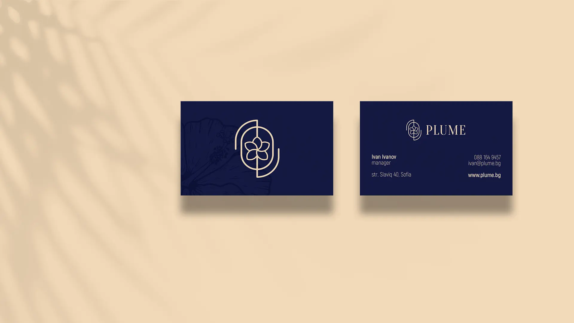 Front and back of Plume's navy business cards on a beige background. The front shows the flower mark. The back has the logo, contact details, and address.